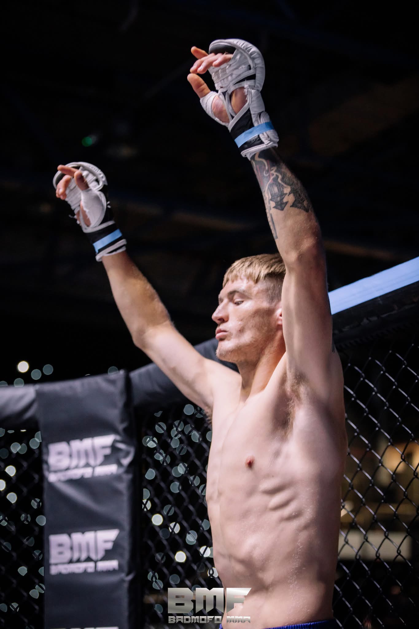 Johnny celebrates his MMA win in the cage